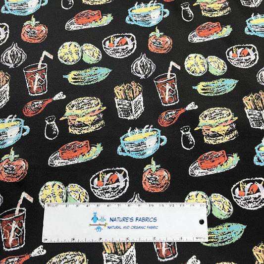 Nature's Fabrics organic fabric with a black background and colorful food doodles.