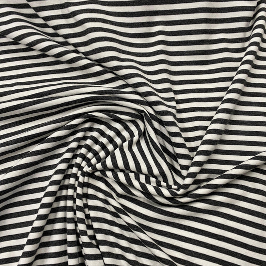 Nature's Fabrics black and white striped organic cotton fabric draped in folds.