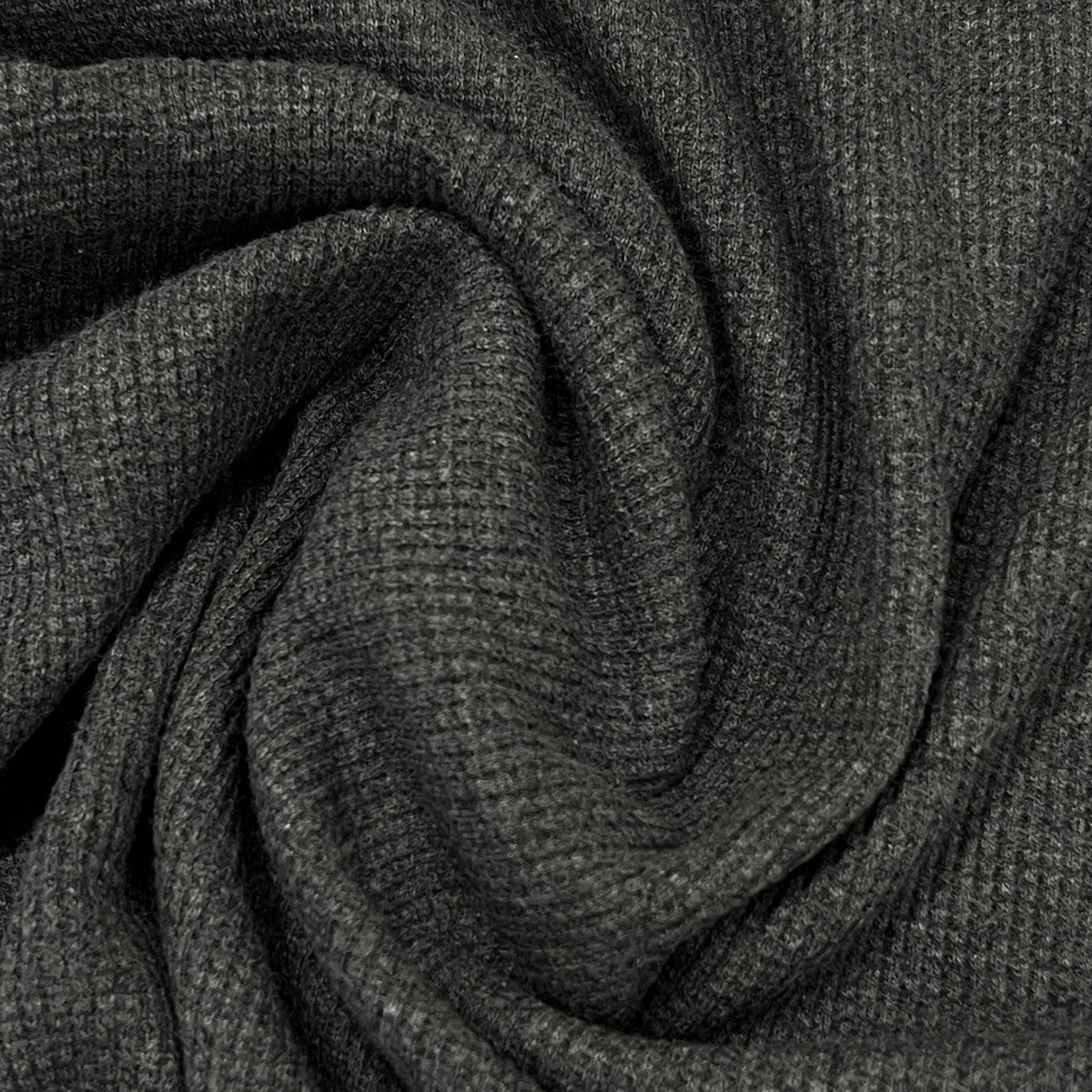 Close-up of draped charcoal grey ribbed natural fabric from Nature's Fabrics