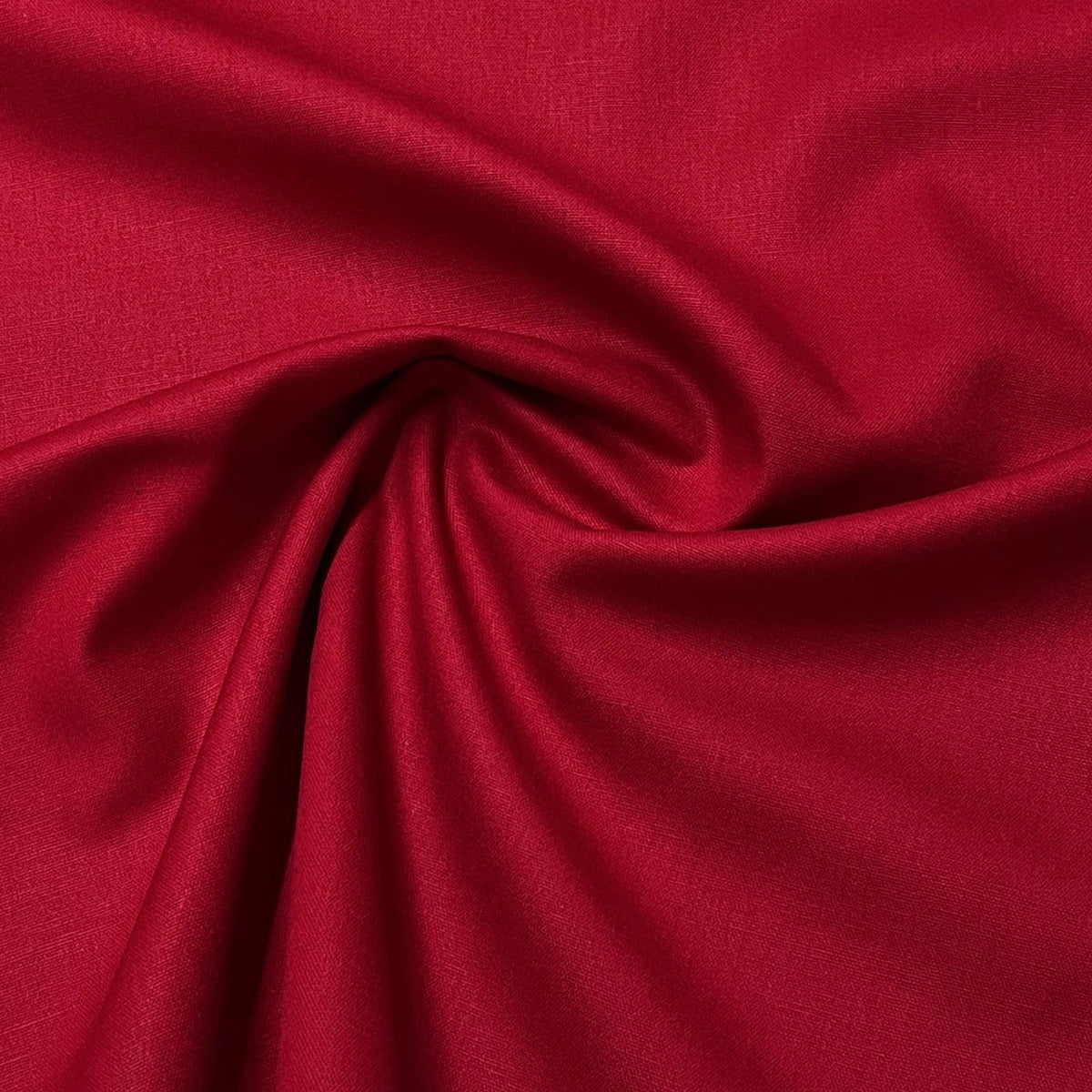 Deep red natural fabric draped in swirls from Nature's Fabrics
