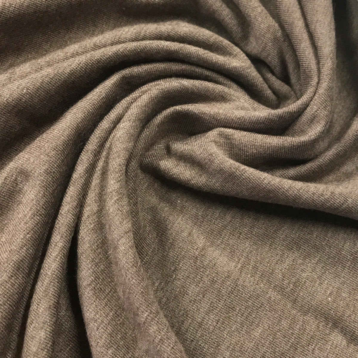 Close-up of draped grey natural fabric by Nature's Fabrics.