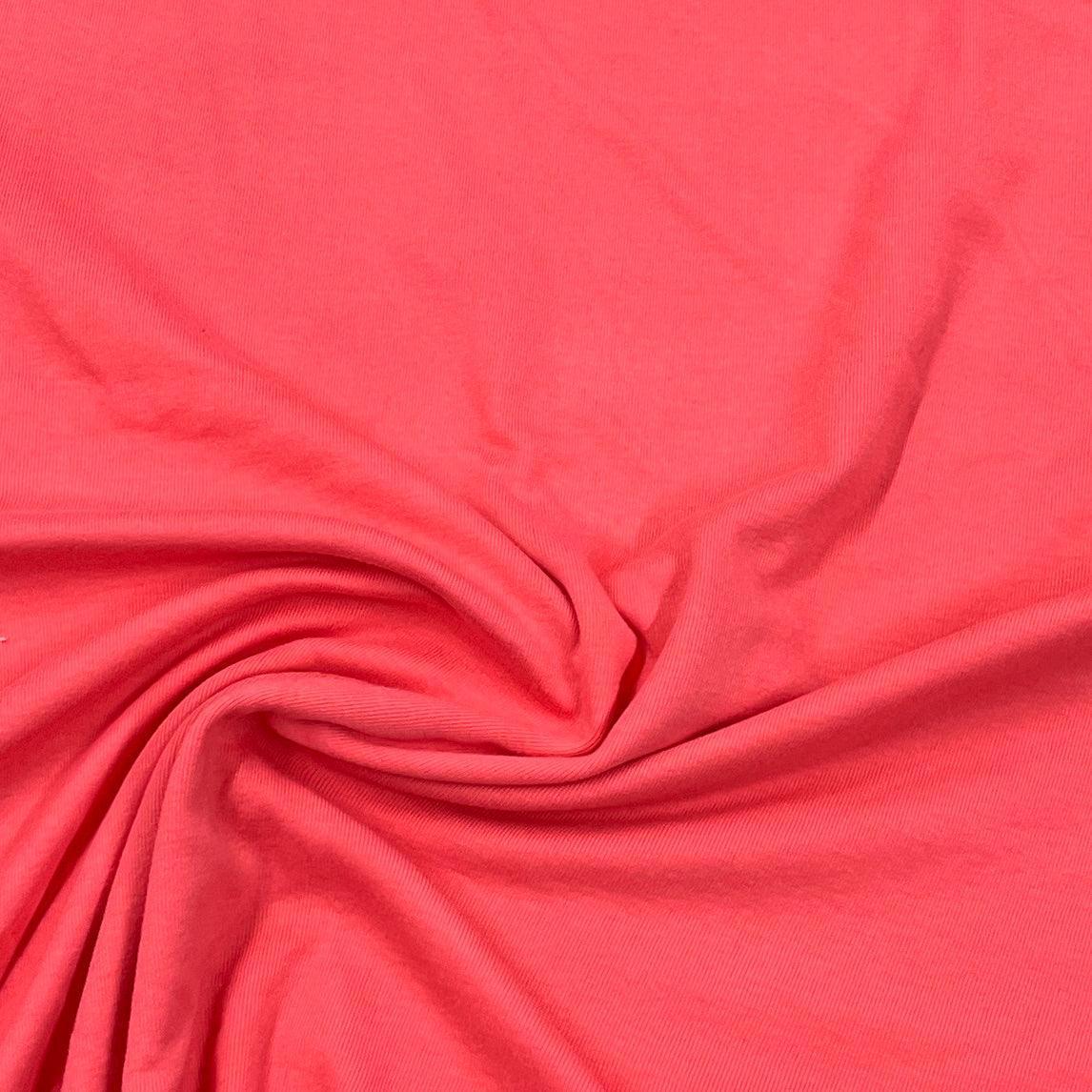 Close-up of draped coral pink natural fabric from Nature's Fabrics.