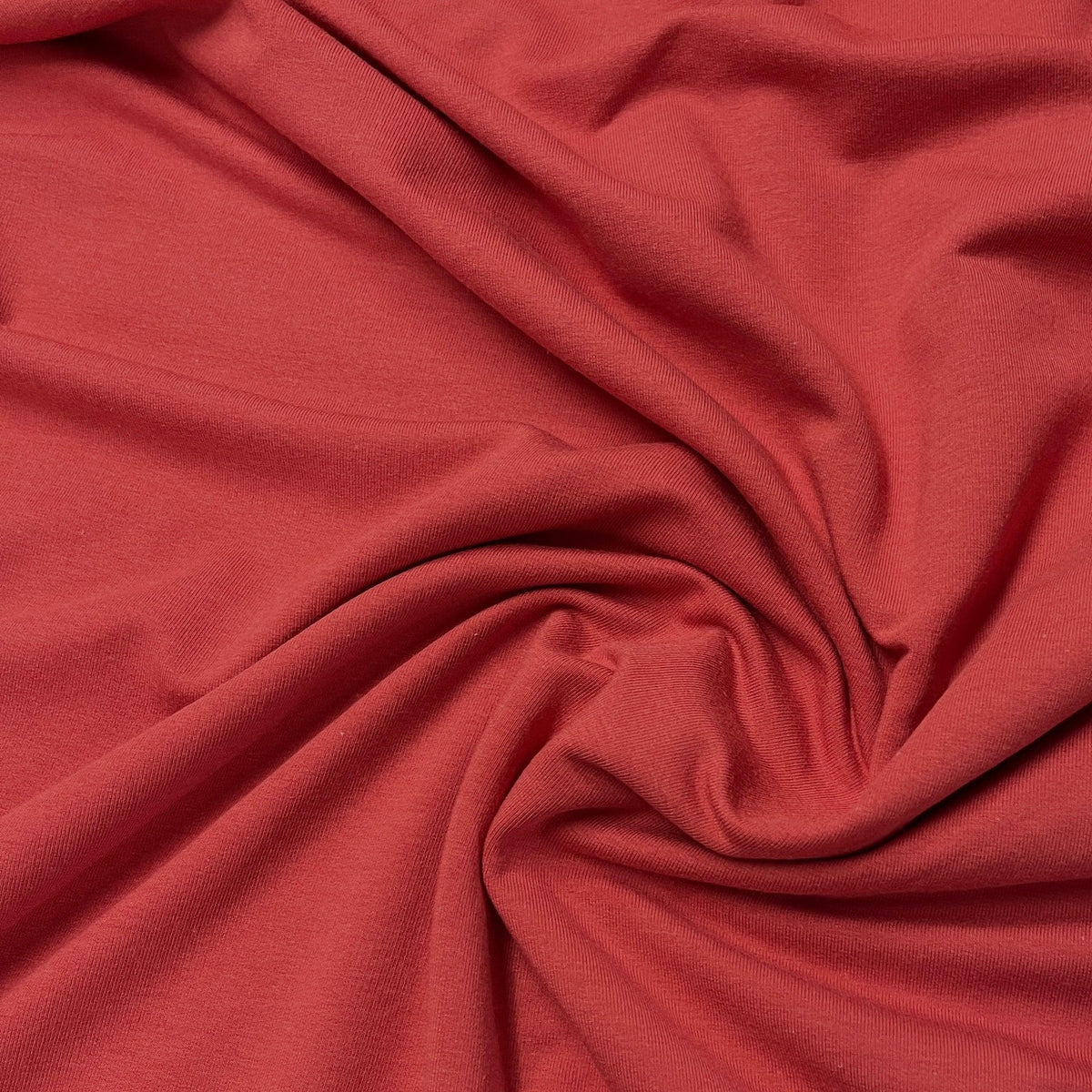 Close-up of draped red premium natural fabric by Nature's Fabrics