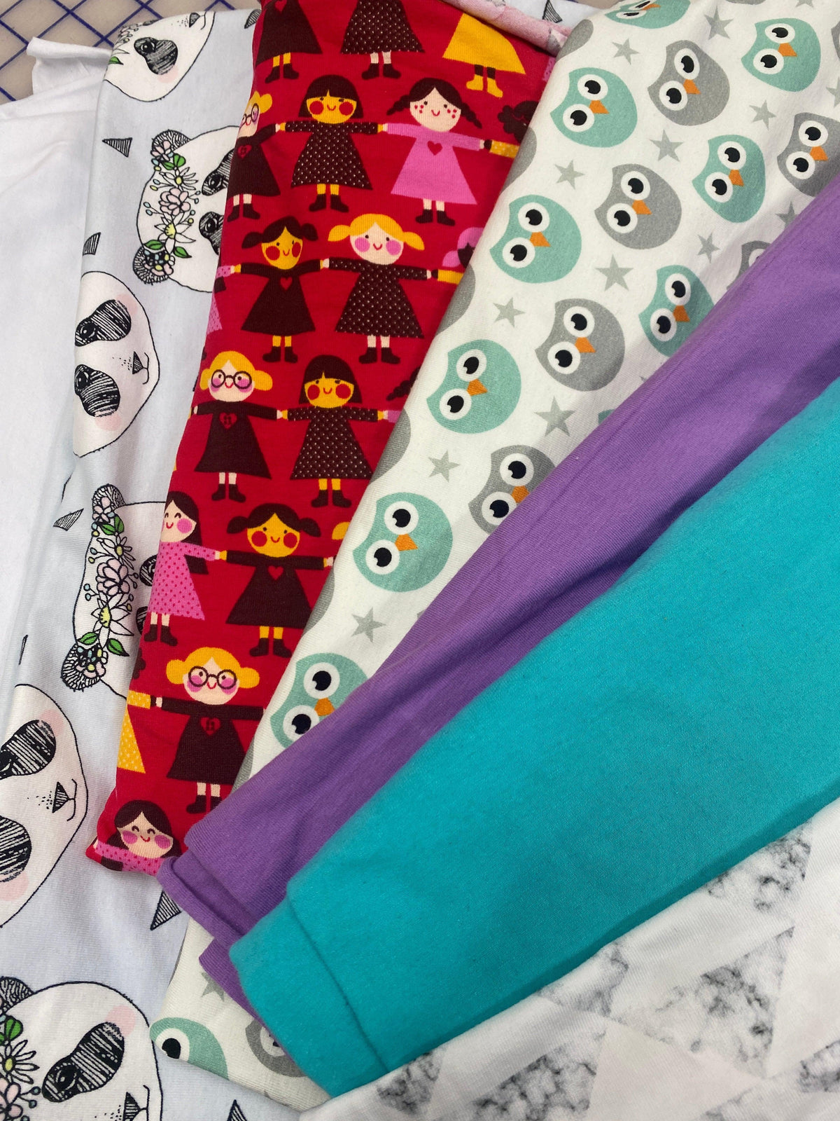Assorted Nature's Fabrics colorful patterned and solid organic cotton fabric rolls