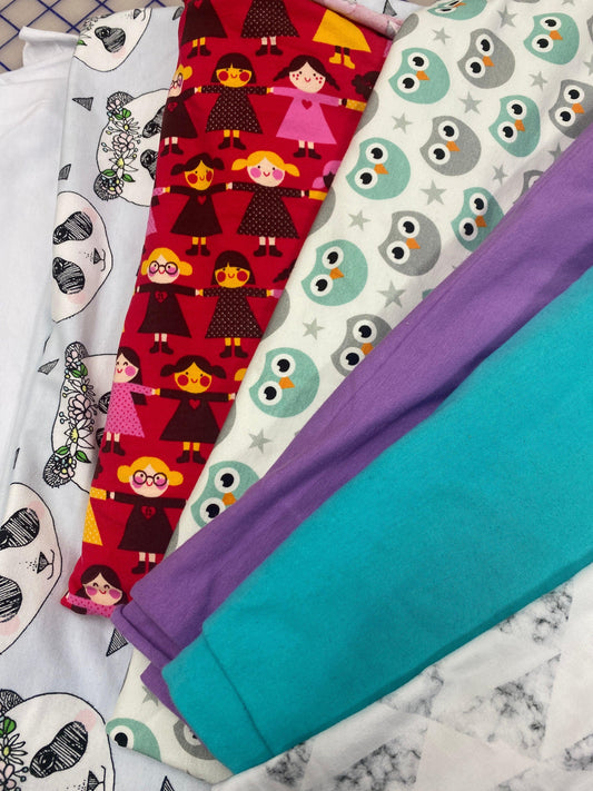 Assorted Nature's Fabrics colorful patterned and solid organic cotton fabric rolls