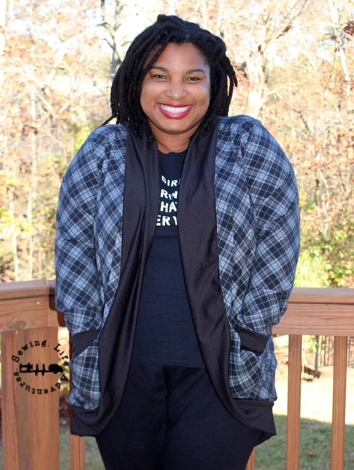Woman wearing a Nature's Fabrics plaid open-front cardigan and black top.