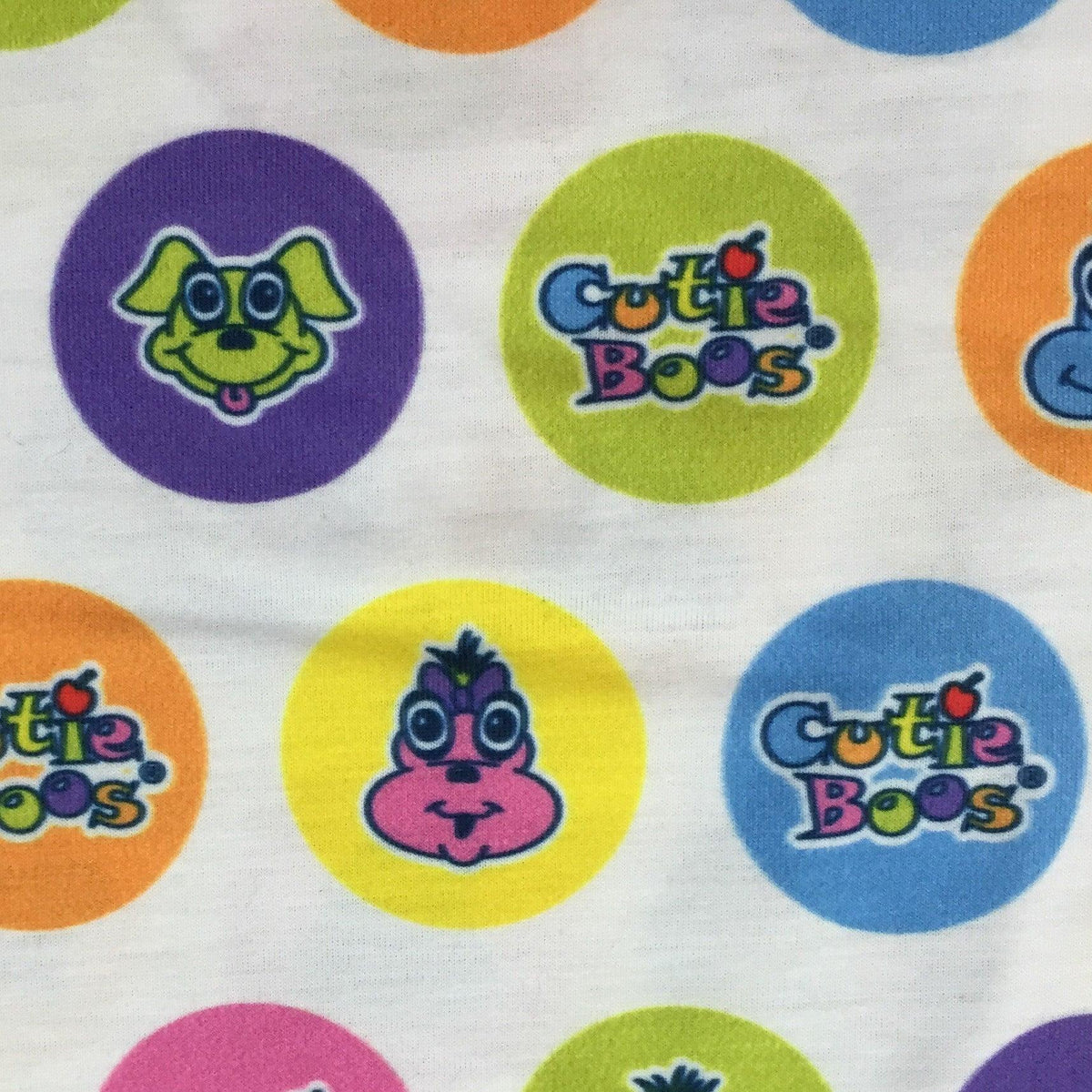 Nature's Fabrics cloth featuring Cutie Boos characters in colorful circles on white background