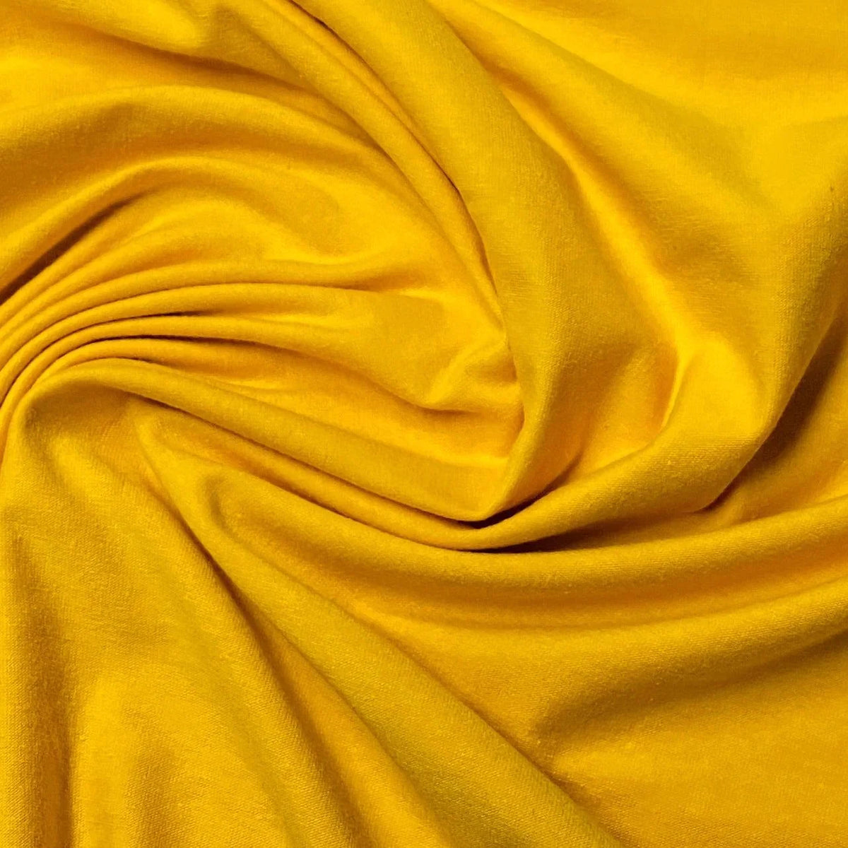 Close-up of draped yellow natural fabric from Nature's Fabrics