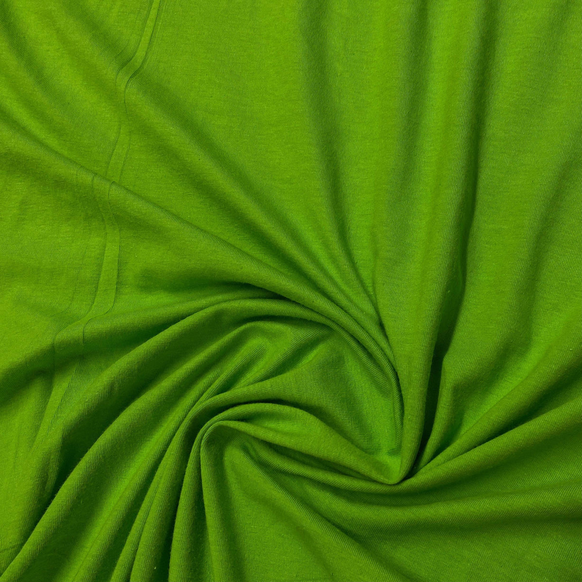 Close-up of crumpled lime green natural fabric from Nature's Fabrics.
