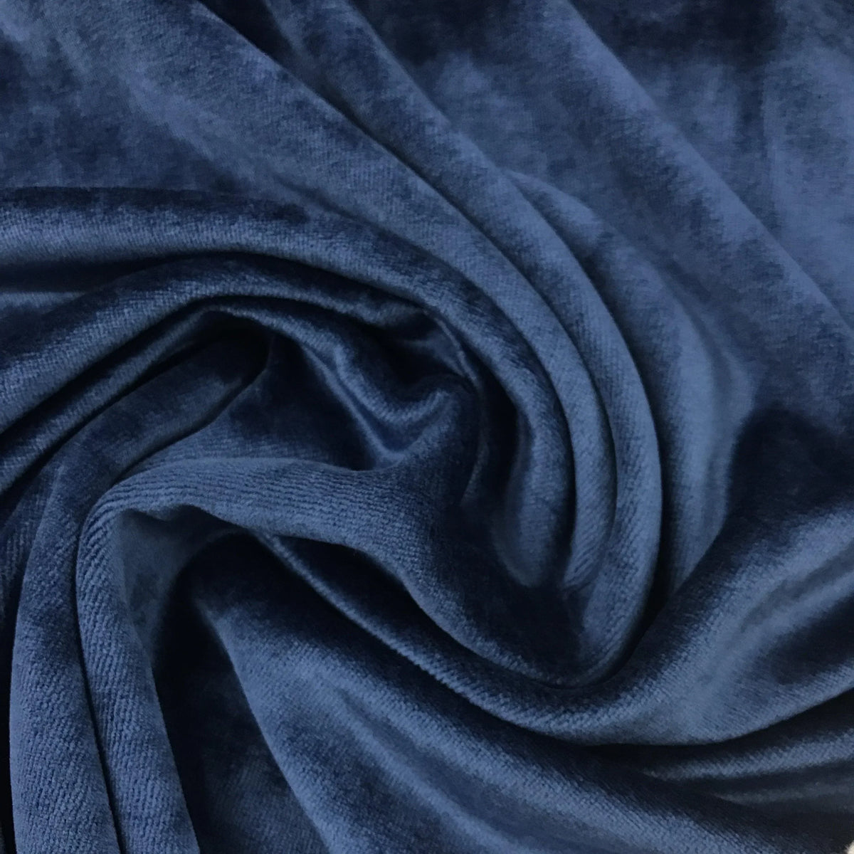Navy blue velvet fabric draped in folds from Nature's Fabrics