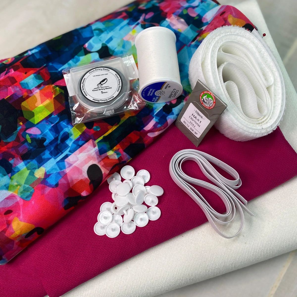 Nature's Fabrics sewing kit with colorful fabric, thread, rotary blades, and buttons