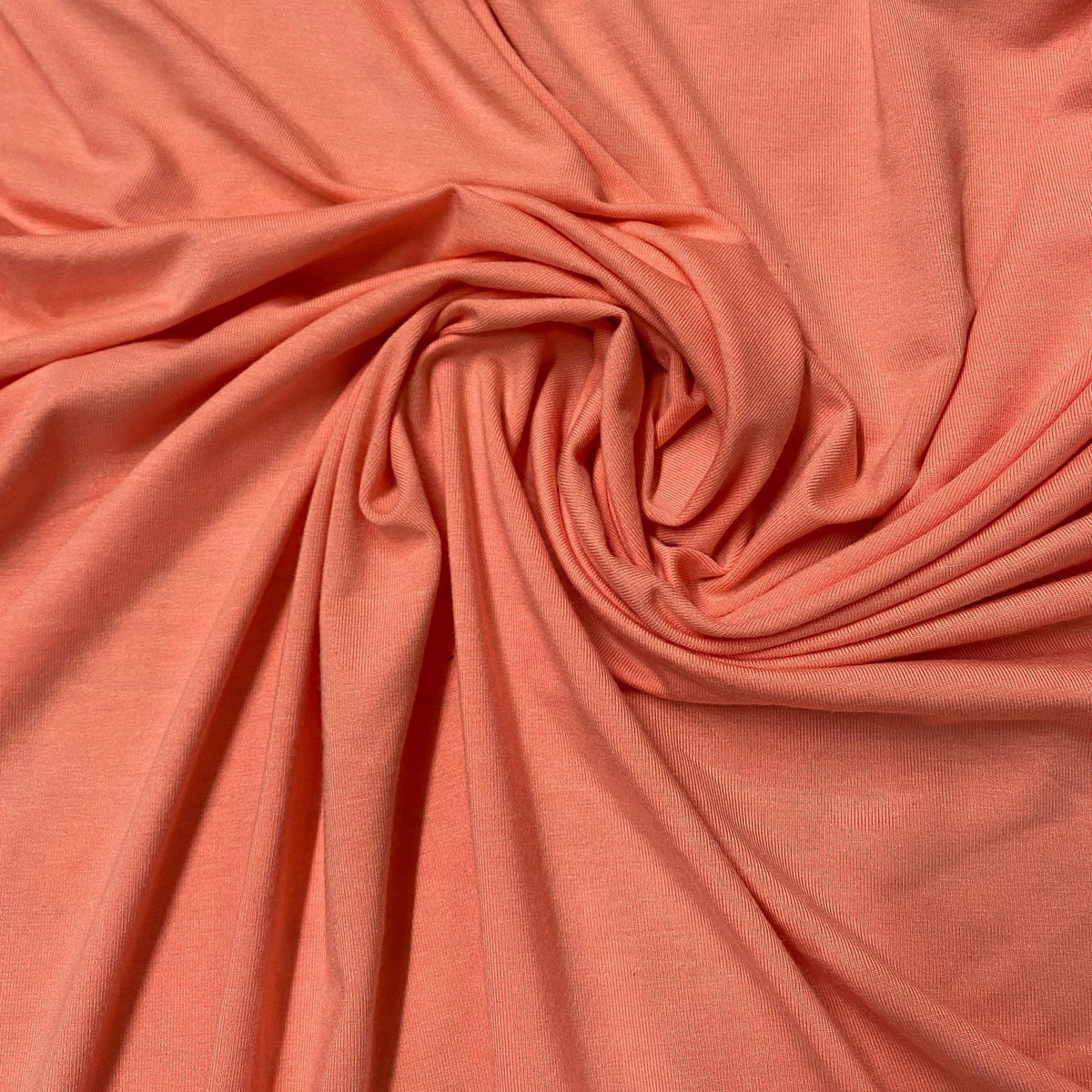 Swirl of coral-colored natural fabric from Nature's Fabrics.