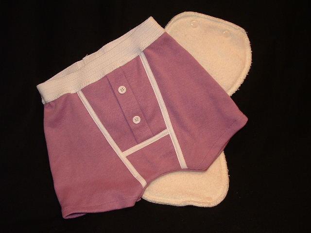 Purple Nature's Fabrics cloth diaper cover with a white absorbent insert on black background