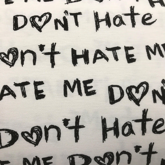 Nature's Fabrics white organic cotton fabric with black 'Don't Hate Me' text and heart patterns