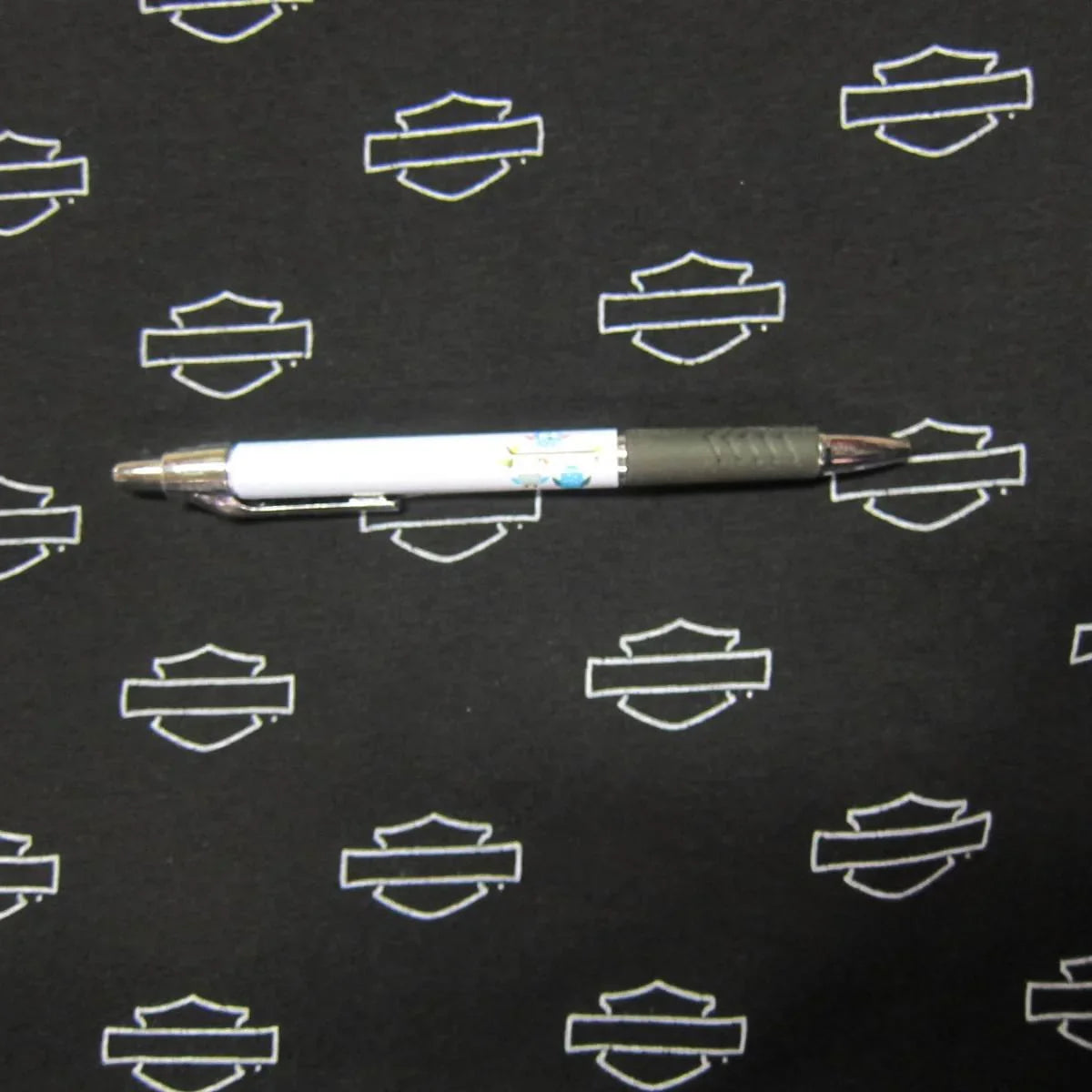 Emblems on Black Cotton/Spandex Jersey Fabric - Nature's Fabrics