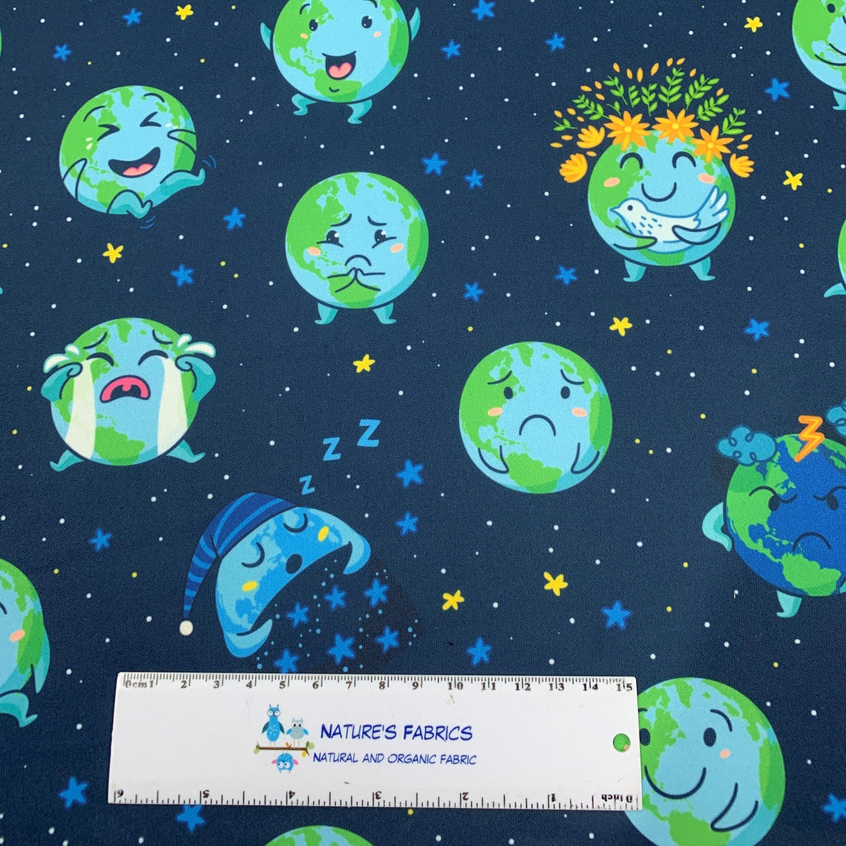 Nature's Fabrics organic cotton fabric with cute illustrated Earth characters on navy blue.