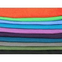 Stacked colorful rolls of premium natural fabric from Nature's Fabrics.
