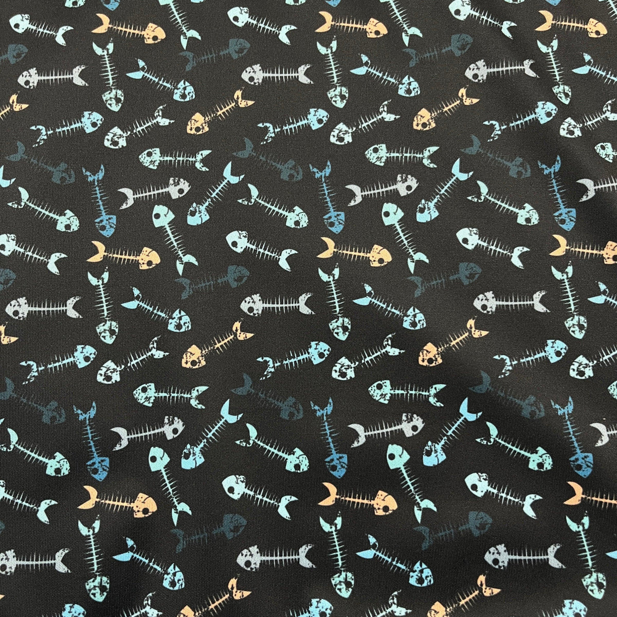 Nature's Fabrics black cotton fabric featuring a colorful fish skeleton pattern