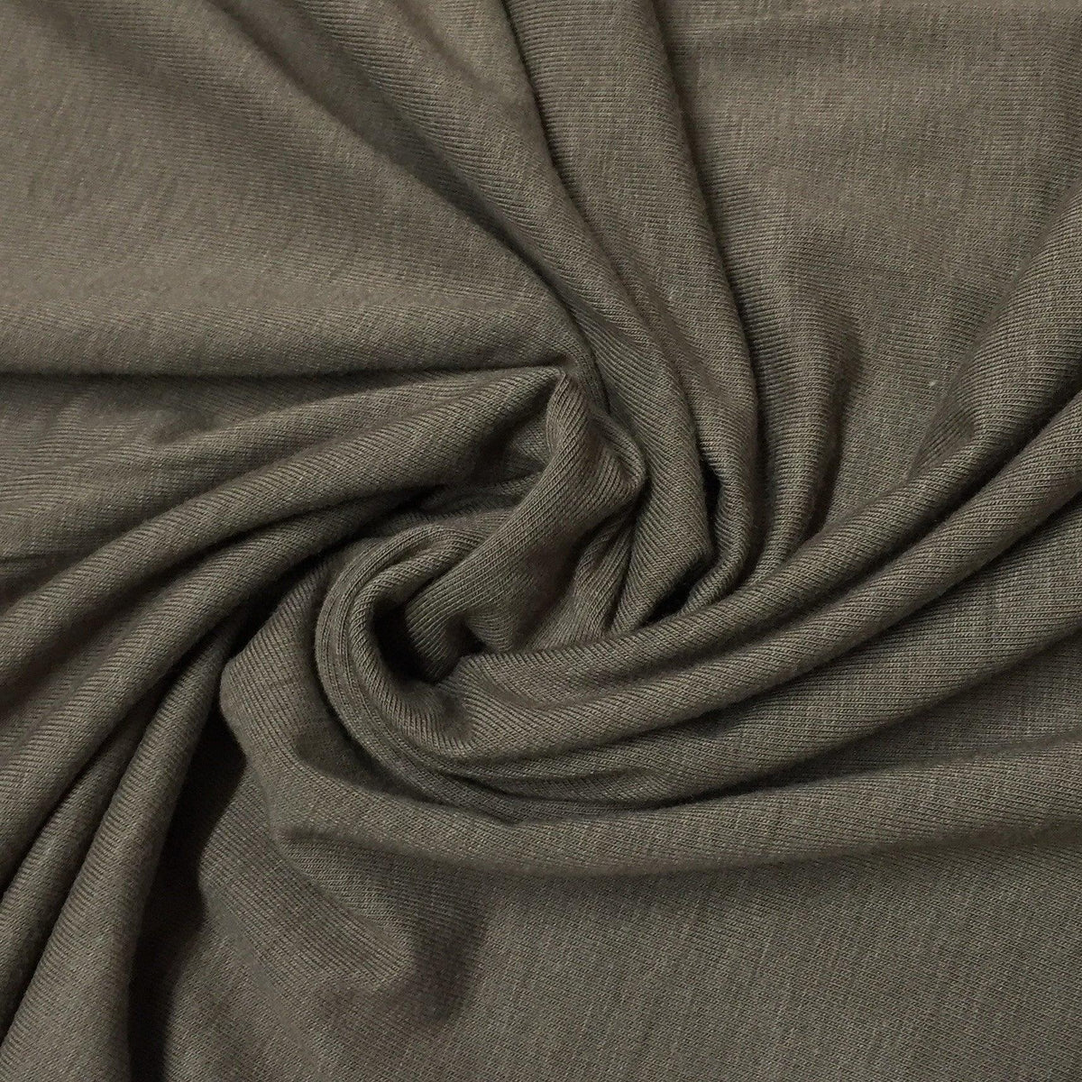 Nature's Fabrics draped brown natural fabric with a subtle textured weave.