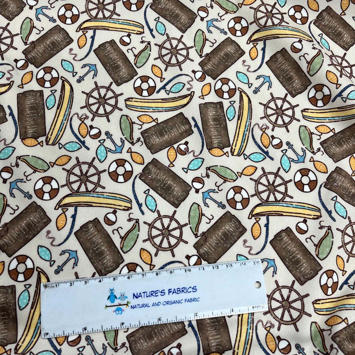 Nature's Fabrics nautical print organic cotton fabric with anchors, wheels, and fish patterns.
