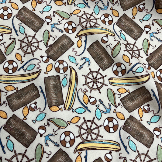 Nature's Fabrics nautical print fabric with fishing signs, anchors, and ship wheels.