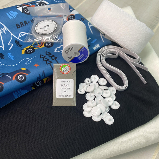 Nature's Fabrics sewing kit with blue patterned cloth, Coats & Clark thread, and sewing notions.