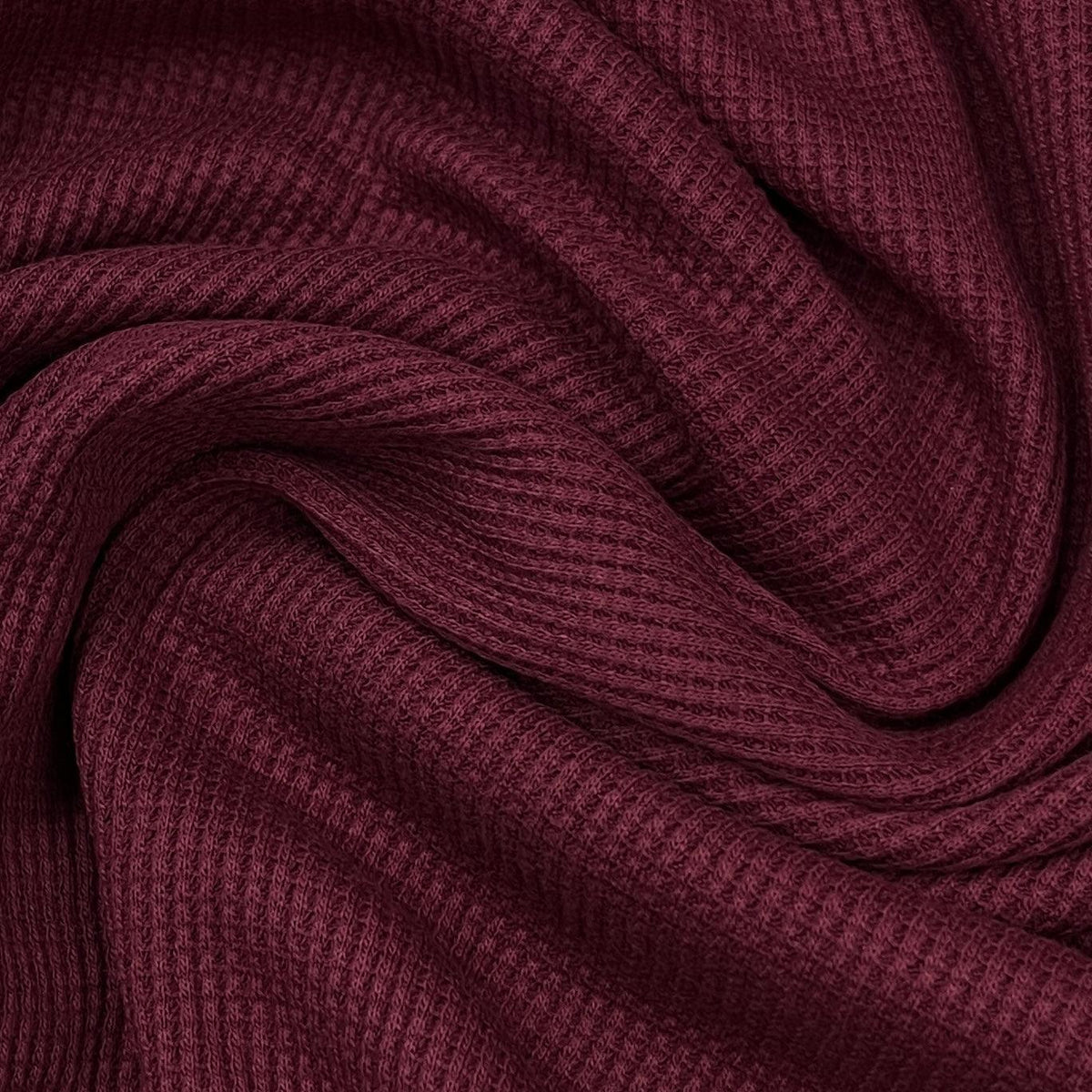 Close-up of maroon ribbed natural fabric from Nature's Fabrics.
