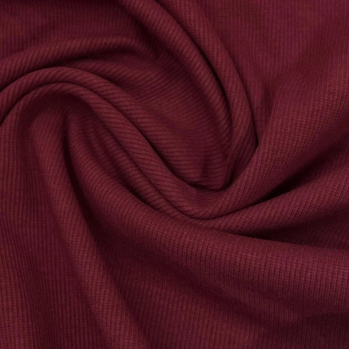 Nature's Fabrics burgundy ribbed knit fabric draped in soft folds