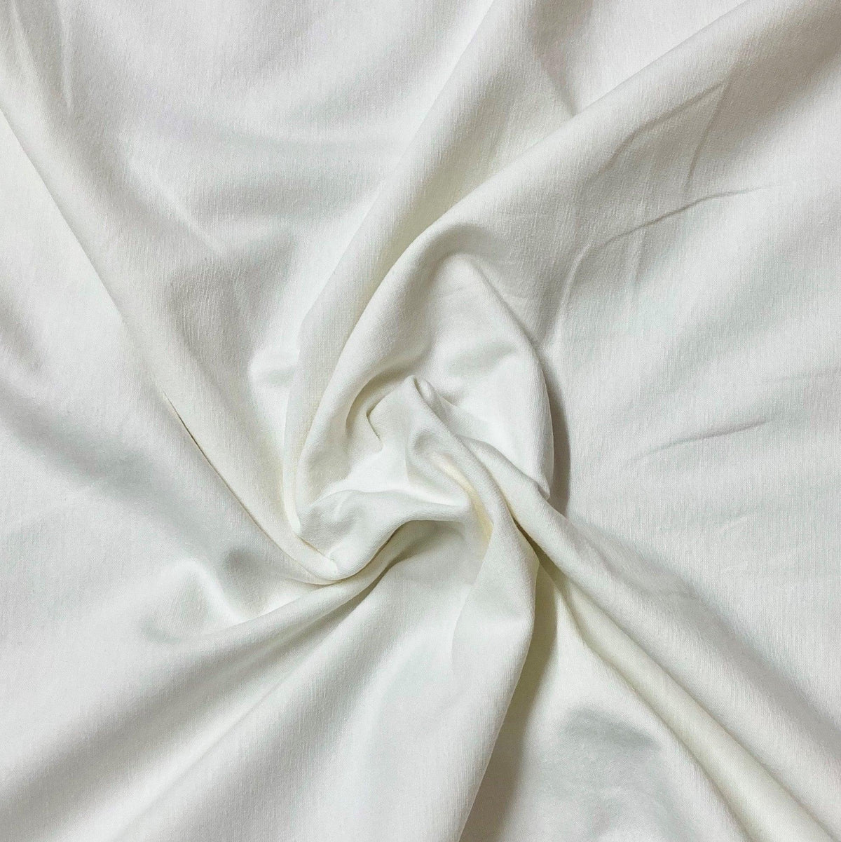 Close-up of draped white natural fabric from Nature's Fabrics