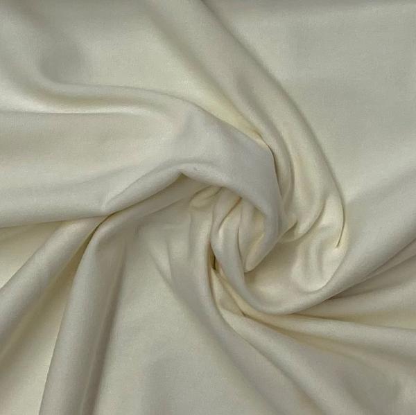 Close-up of draped off-white premium natural fabric by Nature's Fabrics.