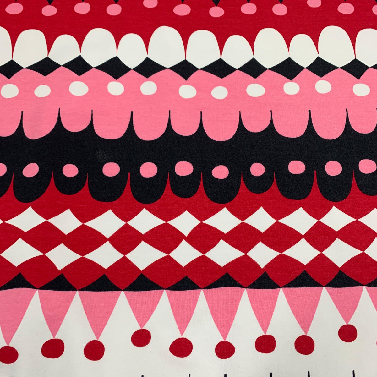 Nature's Fabrics red, pink, black, and white geometric patterned fabric