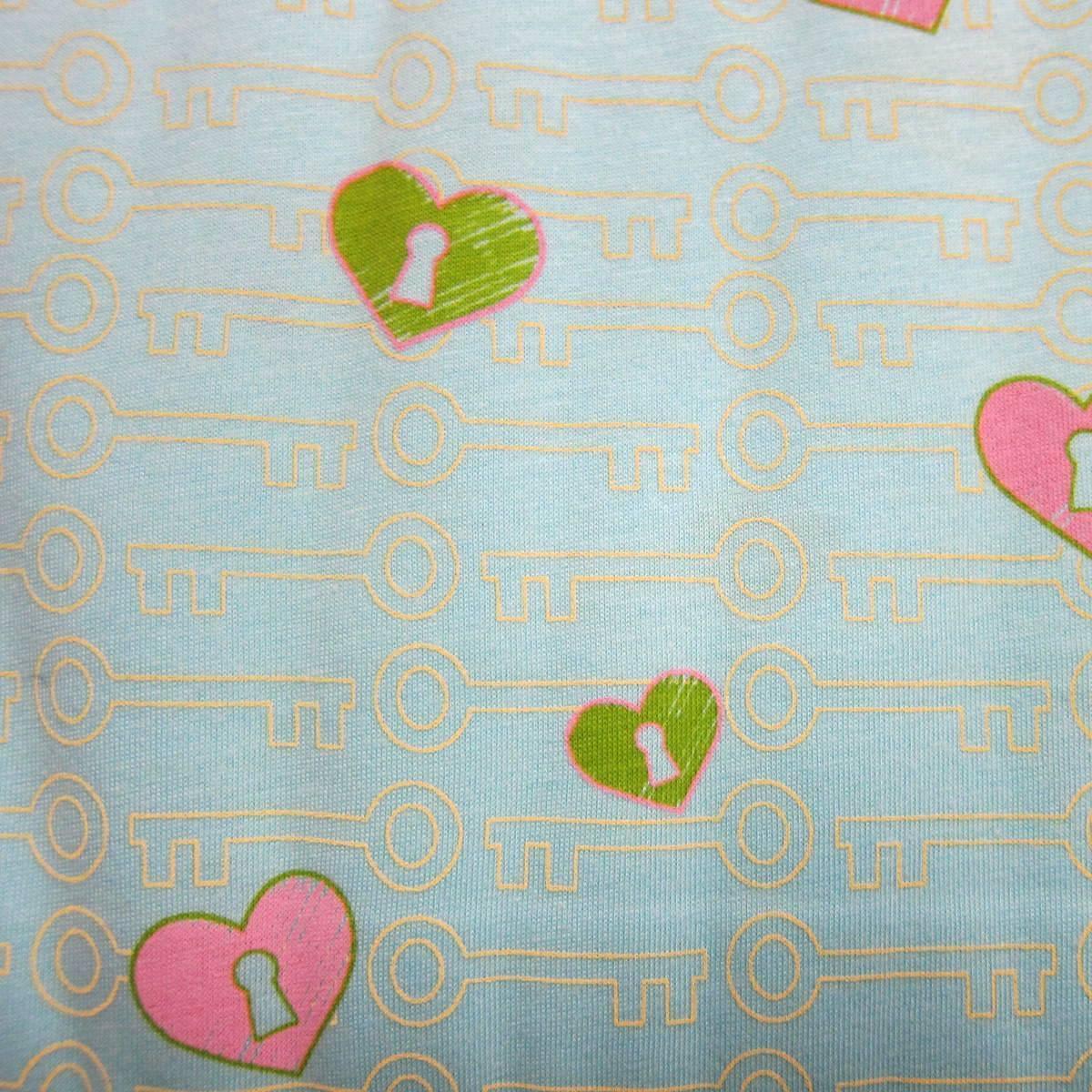 Light blue Nature's Fabrics cotton fabric with pink and green heart keys pattern.