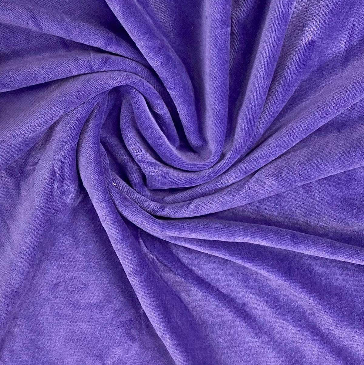 Swirl of premium purple velvet fabric from Nature's Fabrics.