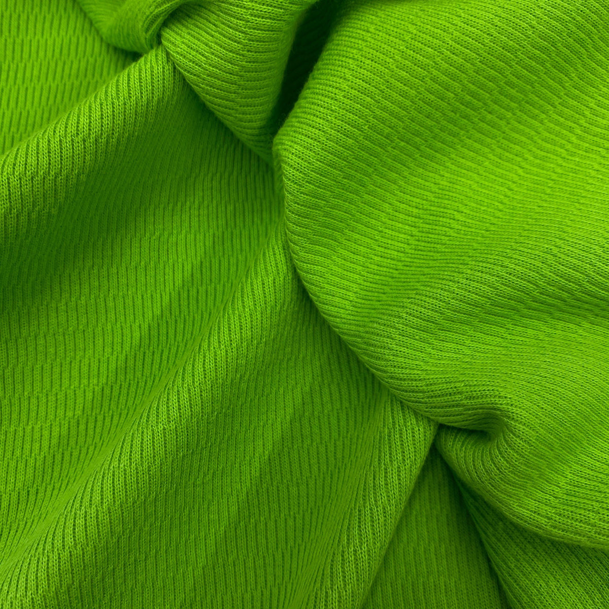 Close-up of draped, ribbed green natural fabric from Nature's Fabrics.