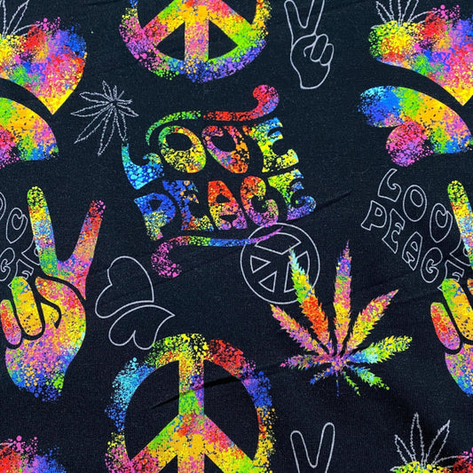 Nature's Fabrics black textile featuring rainbow splatter peace signs, hand gestures, and leaf art.