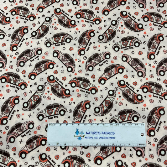 Nature's Fabrics organic cotton fabric with a pattern of vintage cars and hearts.