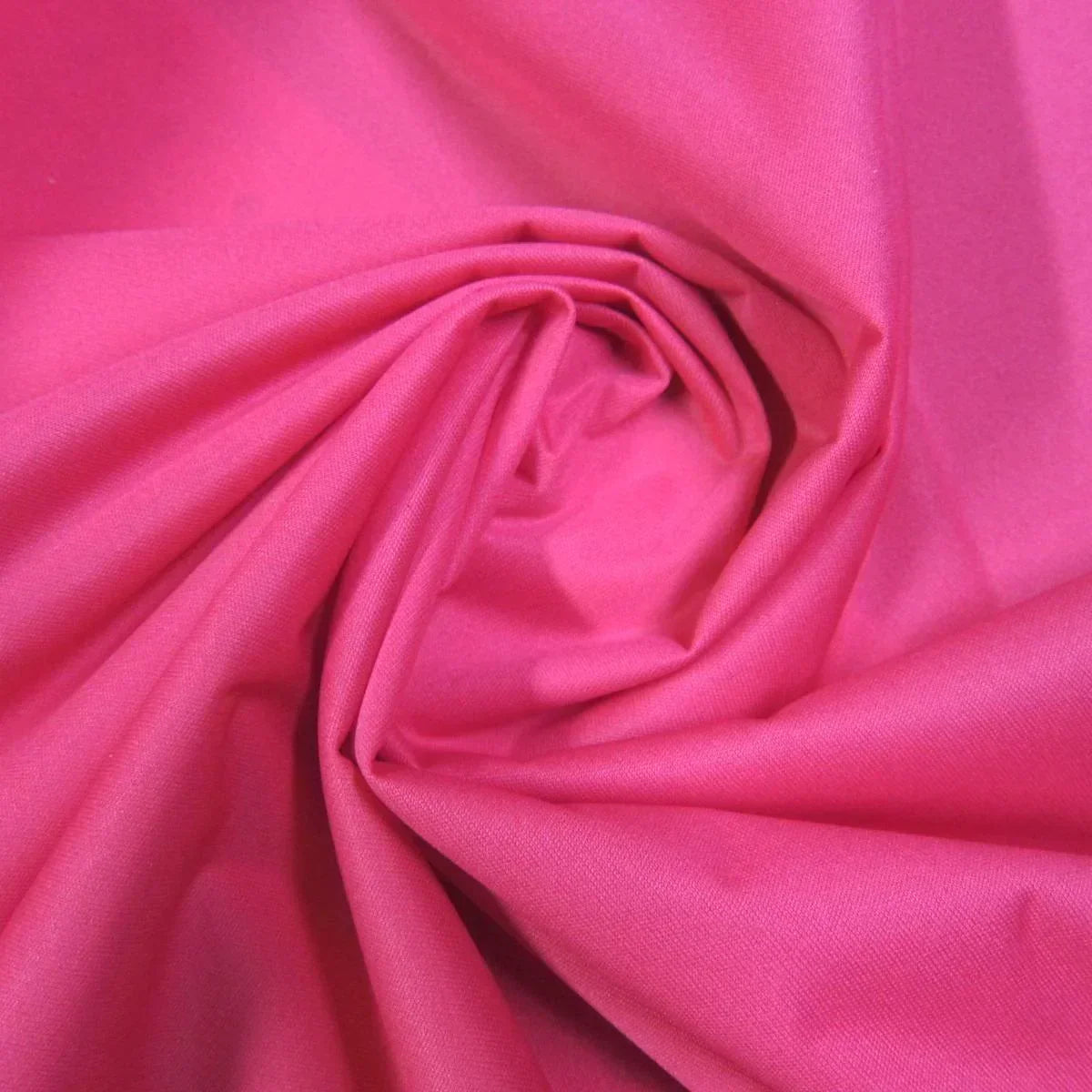 Bright pink natural fabric by the yard from Nature's Fabrics, draped in soft folds.