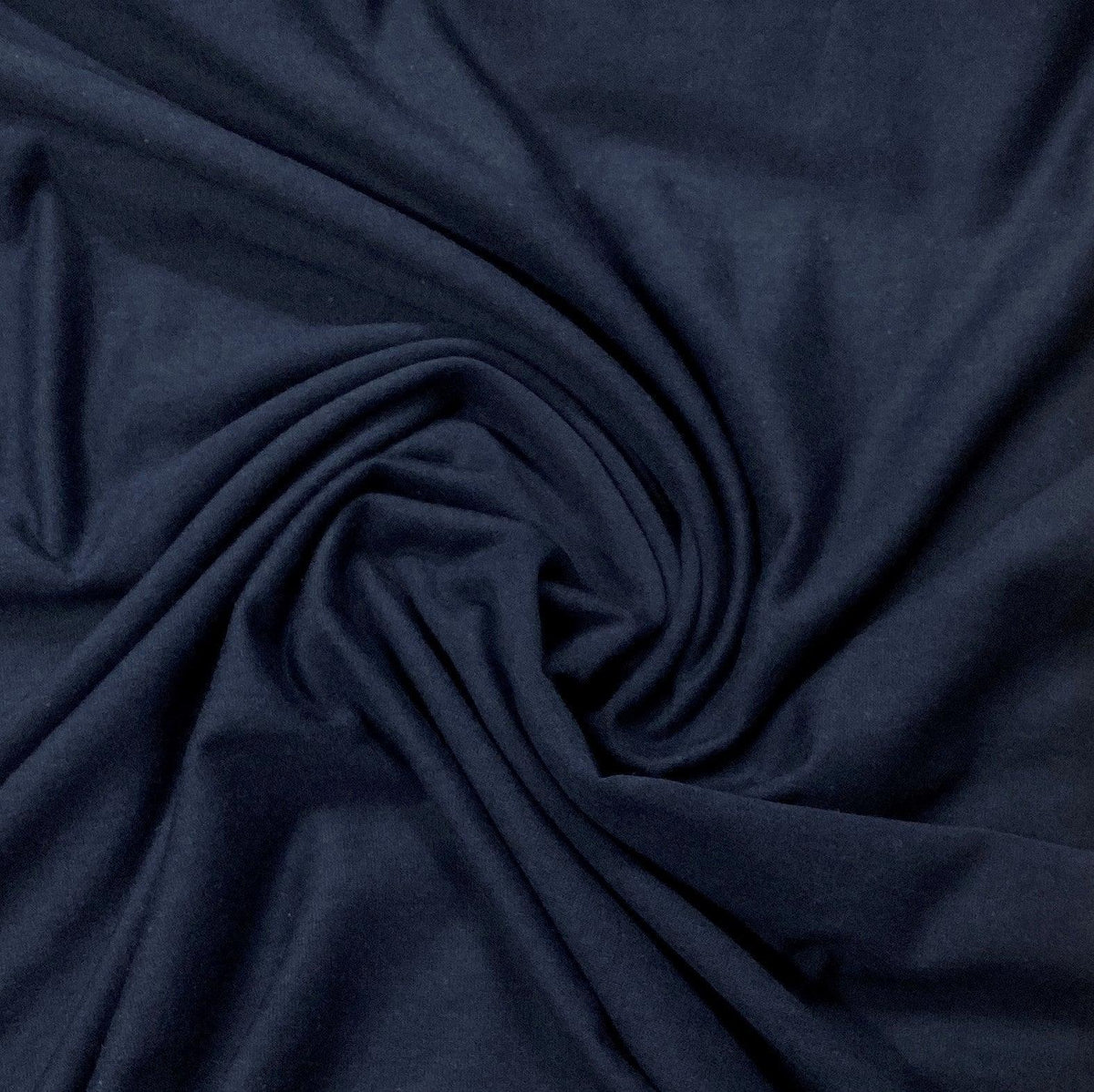 Navy blue natural fabric from Nature's Fabrics draped in a swirl