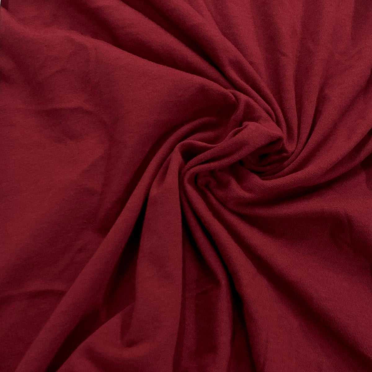Close-up of draped, deep red premium natural fabric from Nature's Fabrics.