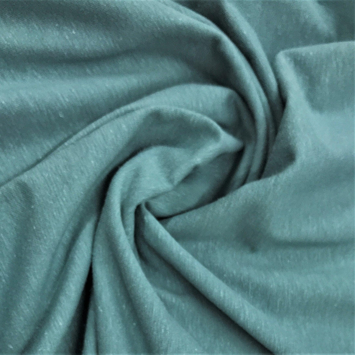 Close-up of draped, sage green natural fabric from Nature's Fabrics.