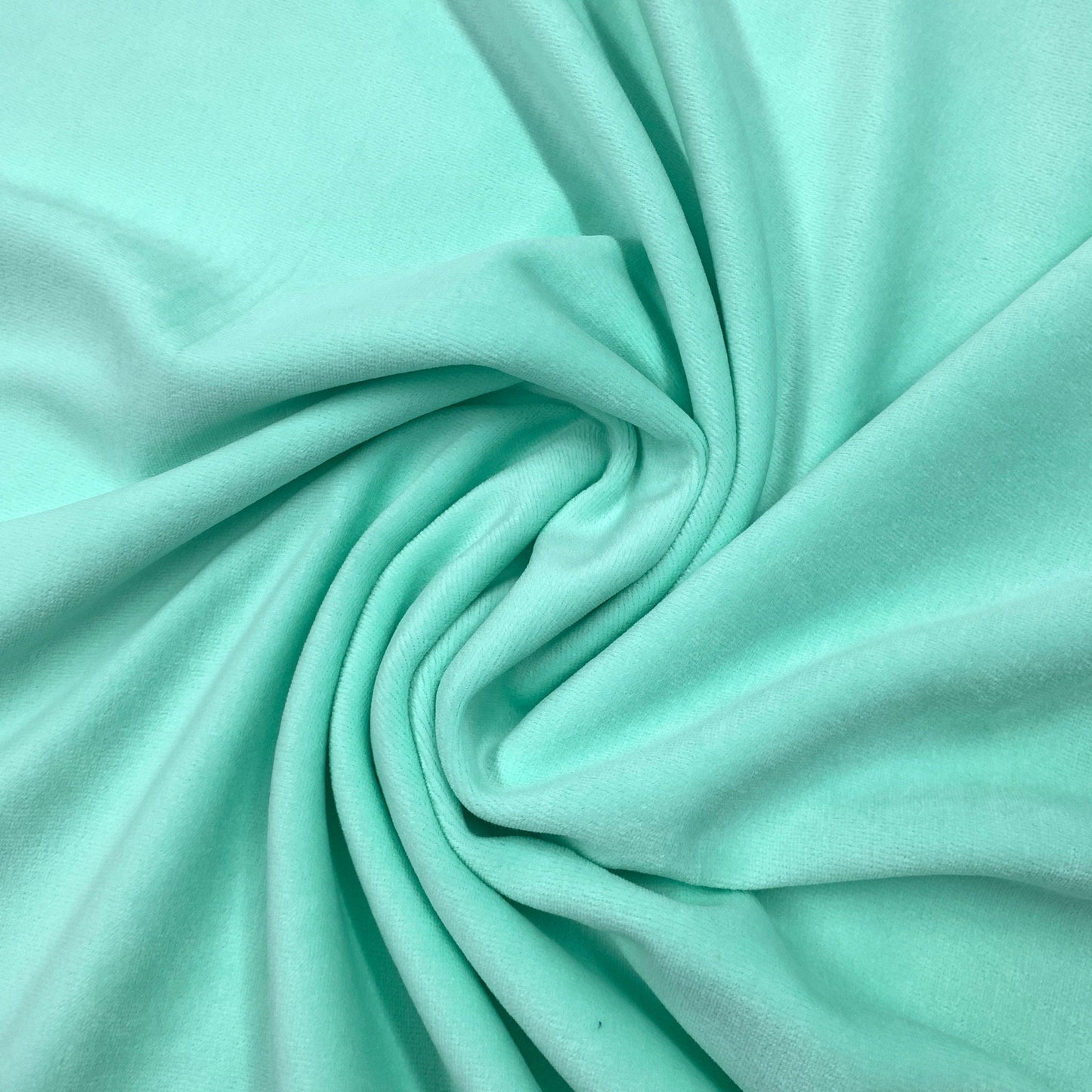 Mint green natural fabric draped in a swirl by Nature's Fabrics