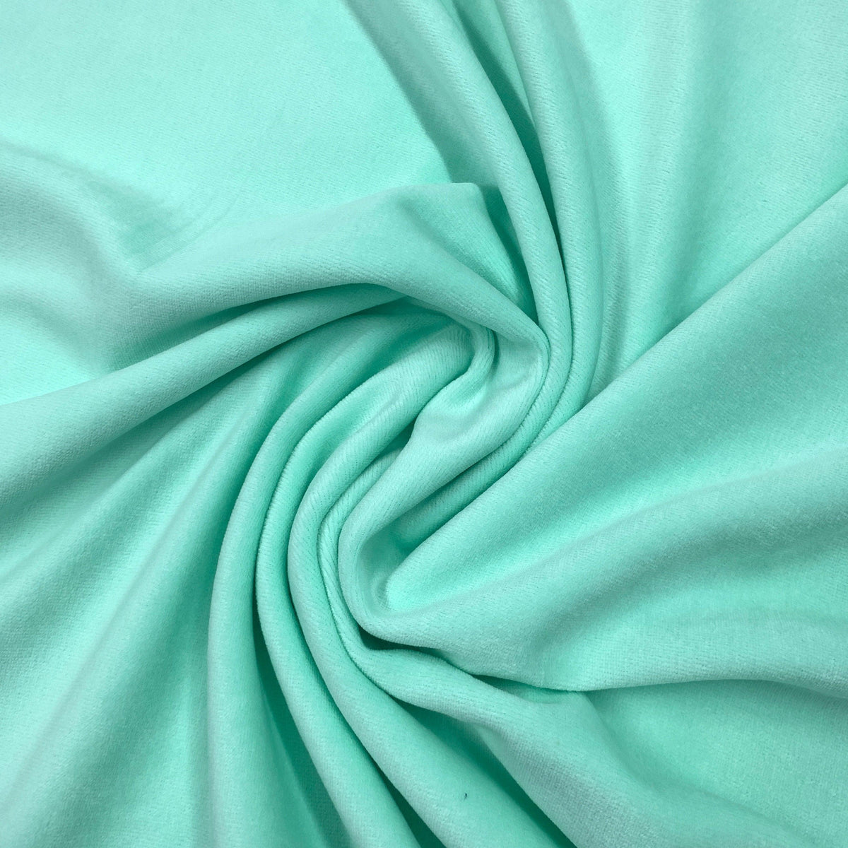Mint green natural fabric draped in a swirl by Nature's Fabrics