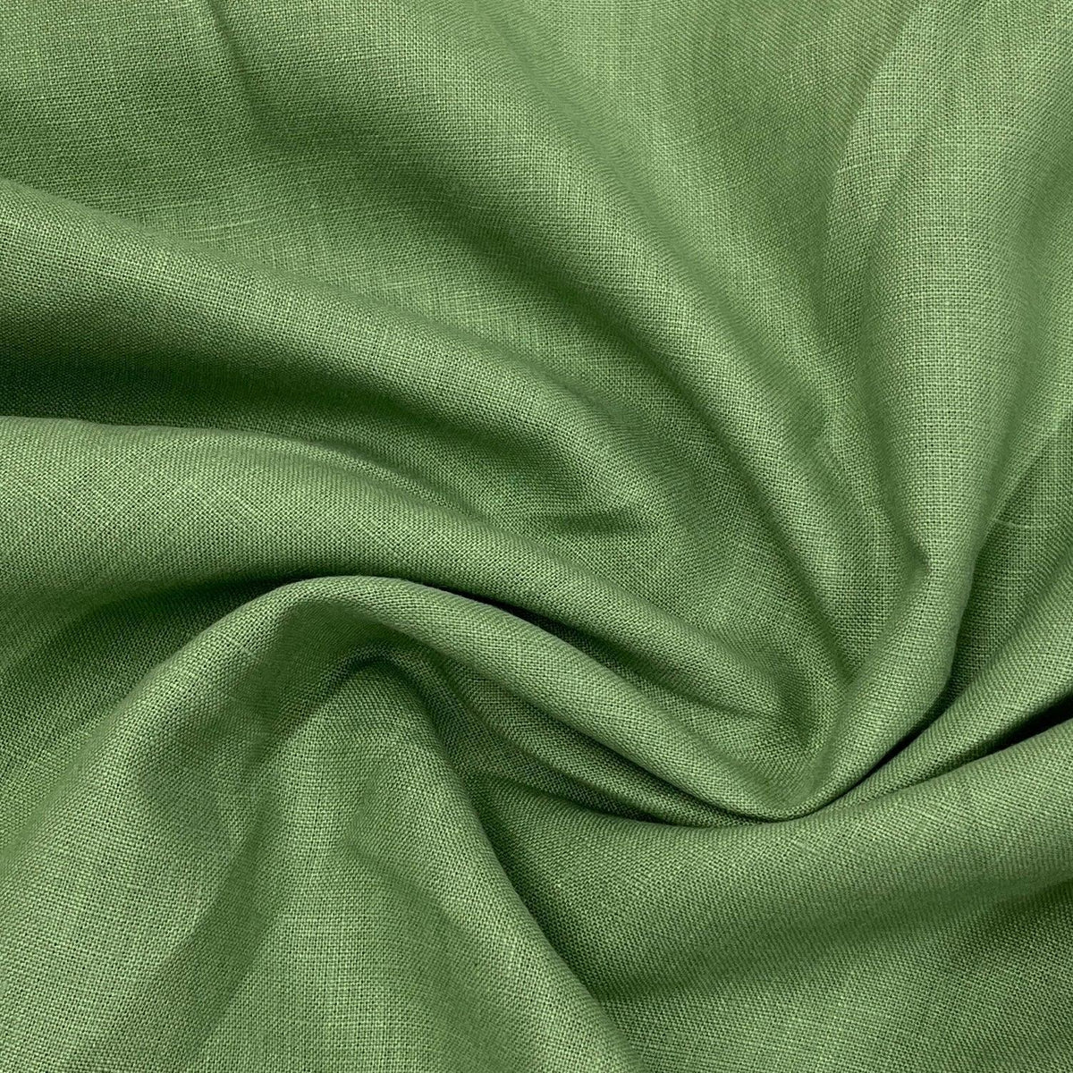 Close-up of draped green natural fabric from Nature's Fabrics.