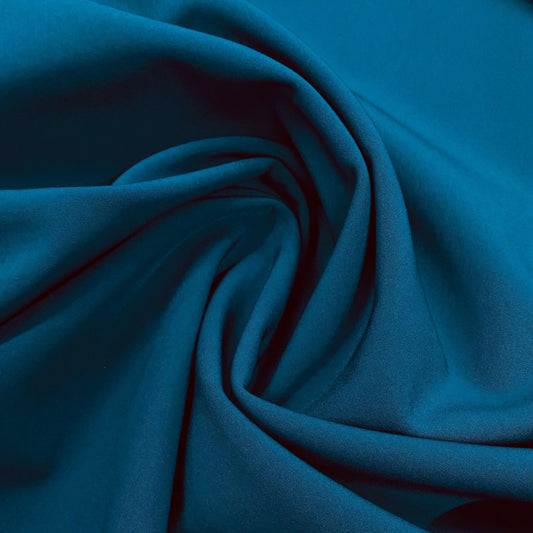 Nature's Fabrics premium teal blue natural fabric draped in soft folds.