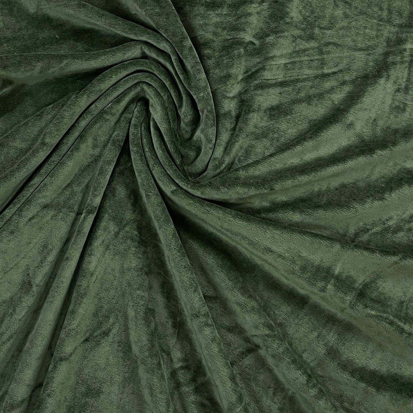Nature's Fabrics dark green velvet fabric draped in a spiral