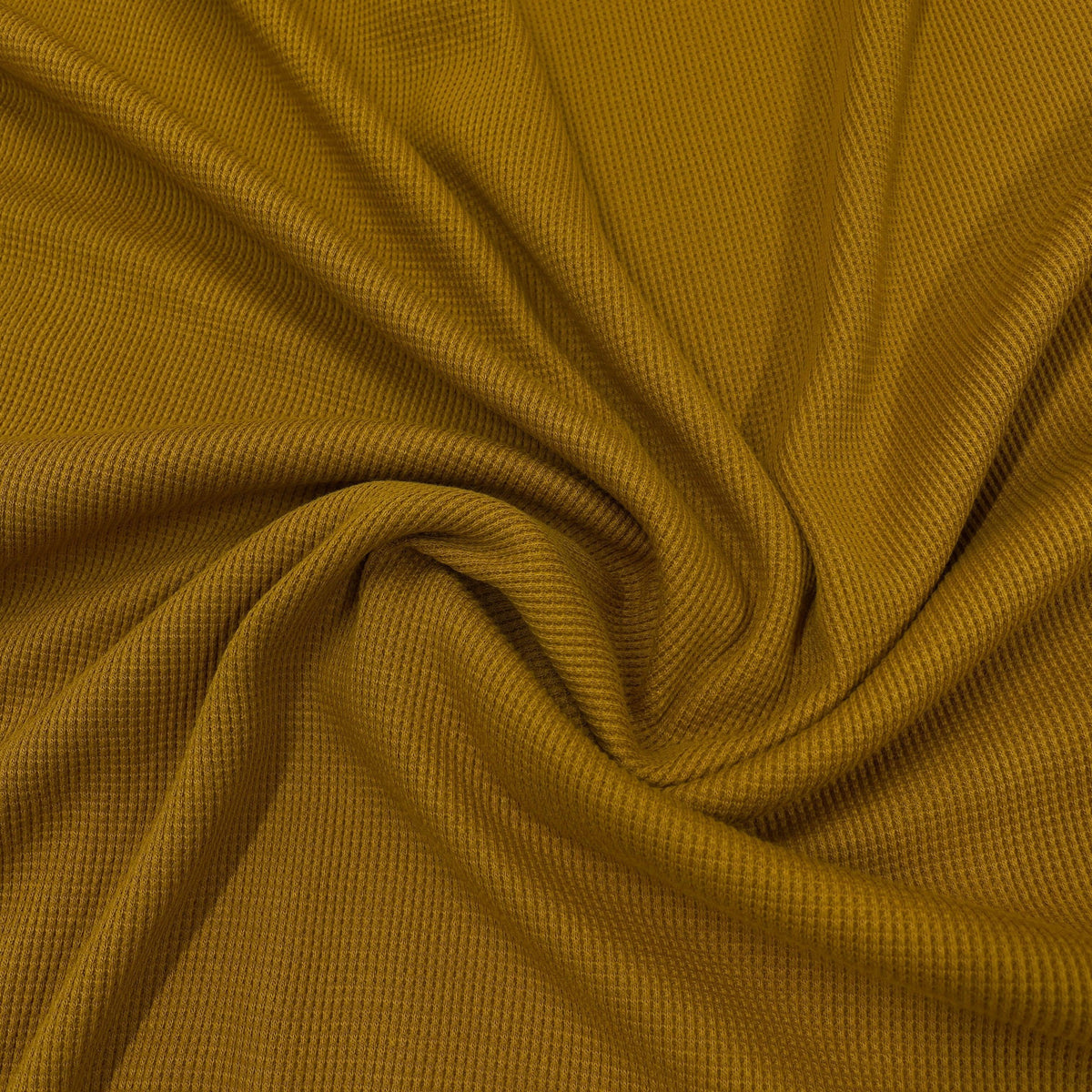 Mustard yellow textured ribbed fabric from Nature's Fabrics draped in soft folds.