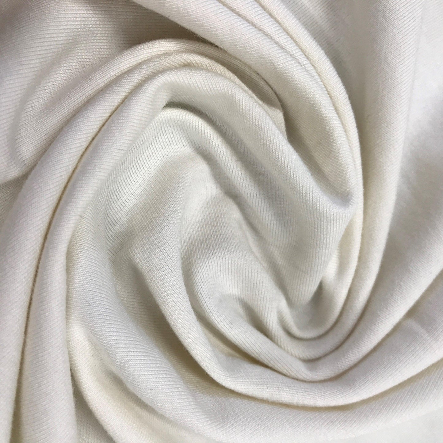 Close-up of swirled white organic cotton fabric from Nature's Fabrics.