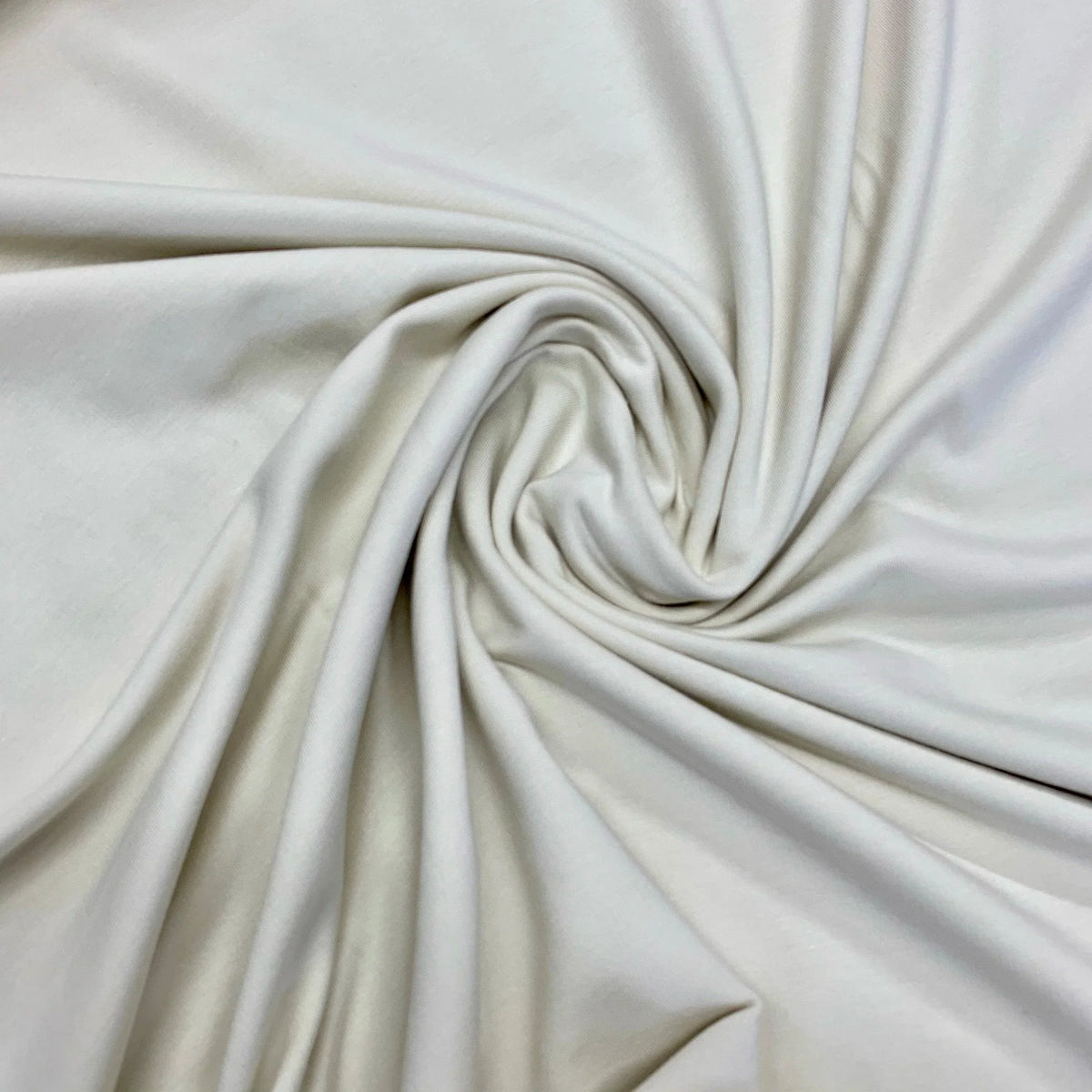 Swirled white organic cotton fabric from Nature's Fabrics.