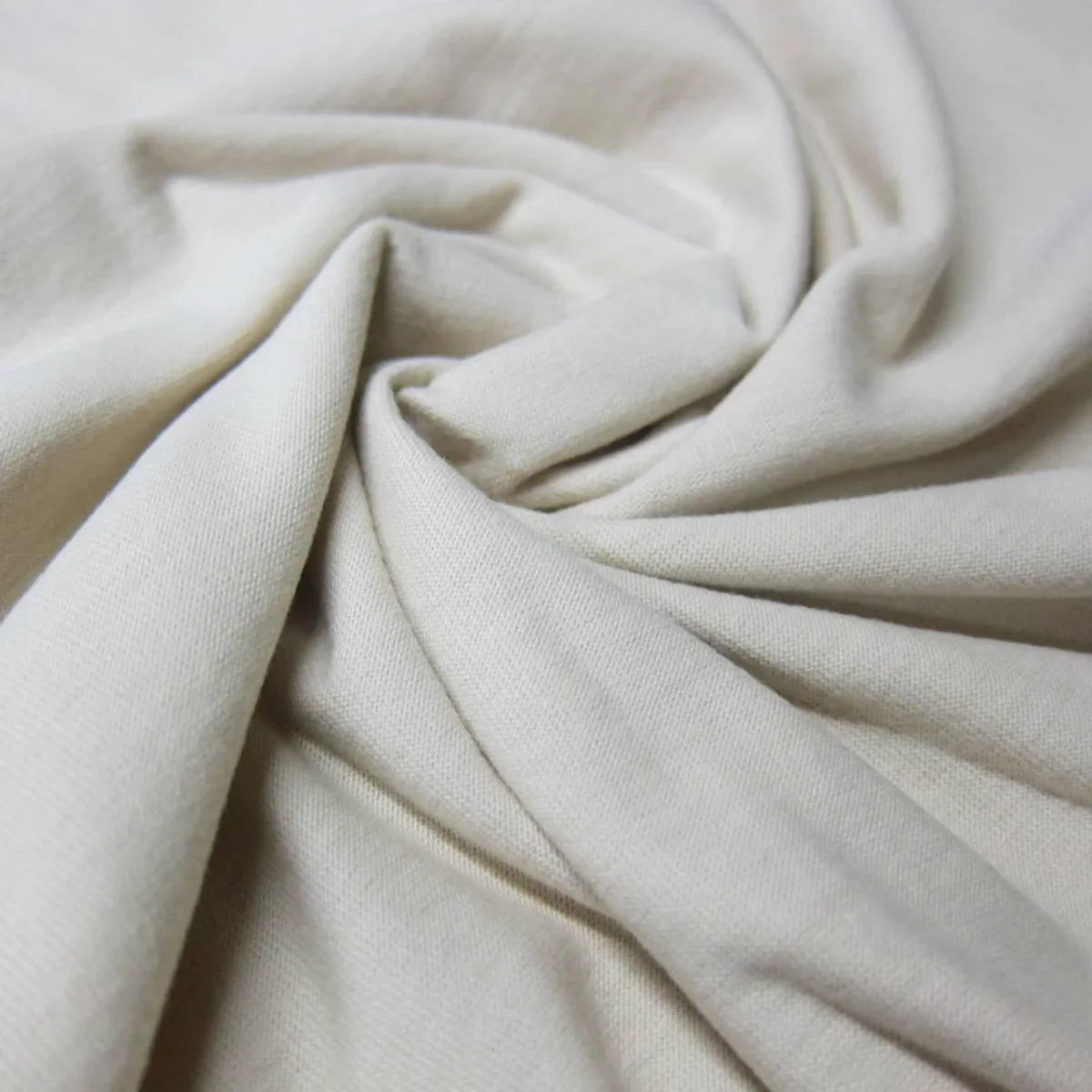 Close-up of draped cream-colored organic cotton fabric from Nature's Fabrics