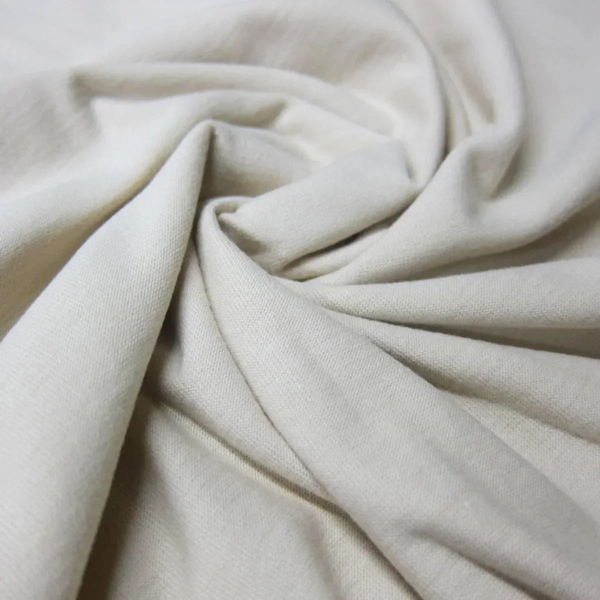 Close-up of draped cream-colored organic cotton fabric from Nature's Fabrics